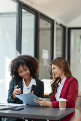 Young Asian and African businesswoman Africans brainstorming on real estate projects. investment plan Financial business together in the office management concept management.