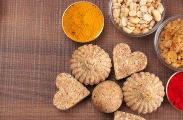 Homemade healthy and sweet groundnut or peanut and Jaggery Laddoo, delicious indian sweet served on a wooden background.Roasted peanut isolated.