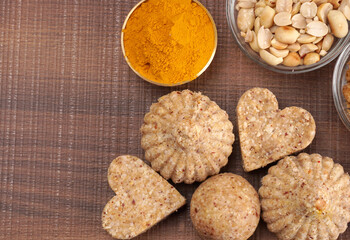 Homemade healthy and sweet groundnut or peanut and Jaggery Laddoo, delicious indian sweet served on a wooden background.Roasted peanut isolated.