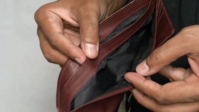 close-up of elderly man hand opening wallet purse retirement ruin bankruptcy old financial problems