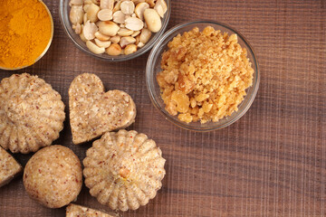 Homemade healthy and sweet groundnut or peanut and Jaggery Laddoo, delicious indian sweet served on a wooden background.Roasted peanut isolated.