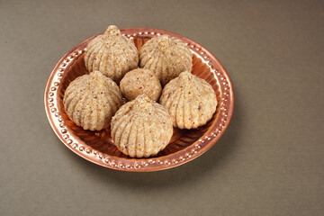 Homemade healthy and sweet groundnut or peanut and Jaggery Laddoo, delicious indian sweet served on a wooden background.Roasted peanut isolated.
