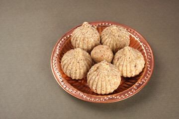 Homemade healthy and sweet groundnut or peanut and Jaggery Laddoo, delicious indian sweet served on a wooden background.Roasted peanut isolated.