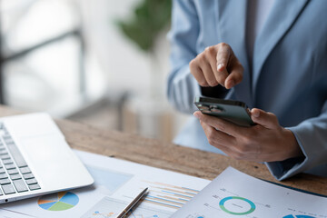Asian businesswoman, investor, insurance salesman pointing at mobile phone to search and view...