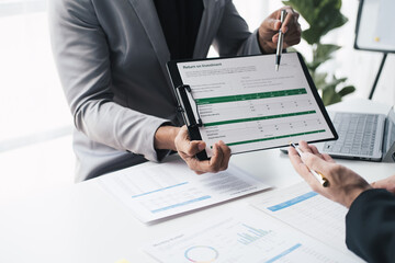 Close up view of investment consultant giving money management plan and advice to his client during th meeting time.