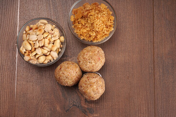 Homemade healthy and sweet groundnut or peanut and Jaggery Laddoo, delicious indian sweet served on a wooden background.Roasted peanut isolated.