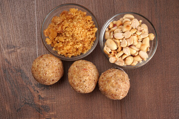 Homemade healthy and sweet groundnut or peanut and Jaggery Laddoo, delicious indian sweet served on a wooden background.Roasted peanut isolated.