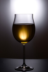 Glass of white wine on black background