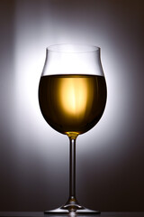 Glass of white wine on  white background