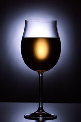 Glass of white wine on black background