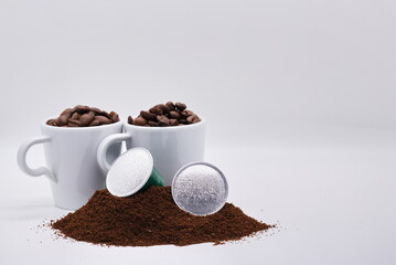 Close-up of coffee capsules and cups