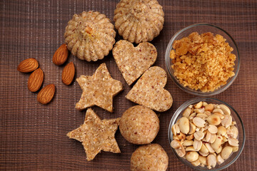 Homemade healthy and sweet groundnut or peanut and Jaggery Laddoo, delicious indian sweet served on a wooden background.Roasted peanut isolated.