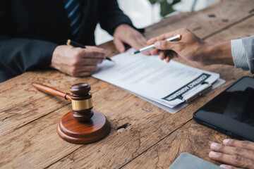 Close up view of young professional lawyer giving legal advice to his client. Law firm concept.