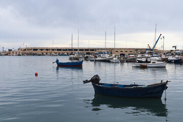 Fototapeta na wymiar Fishing boats in old harbor of Bari, Puglia, Italy.