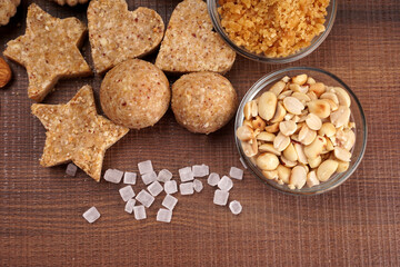 Homemade healthy and sweet groundnut or peanut and Jaggery Laddoo, delicious indian sweet served on a wooden background.Roasted peanut isolated.
