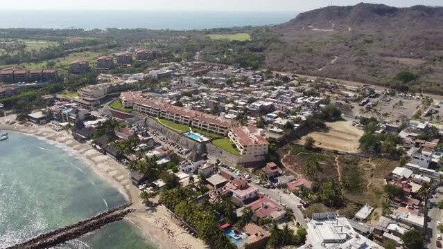 Aerial of a fishing village and the shore in Punta Mita, Puerto Vallarta Mexico on a sunny day