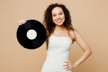 Happy fun beautiful young woman bride wear wedding dress posing hold in hand music disc look camera...