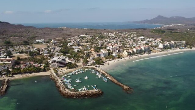Aerial of boats parked at the marina in Punta Mita with Puerto Vallarta in the background in Mexico