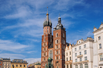 Fototapeta na wymiar St Mary Basilica and Adam Mickiewicz statue in Old Town, historic part of Krakow, Poland