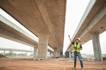 Highway engineering works on construction project planning. Engineer supervising the construction of a concrete bridge at a construction site
