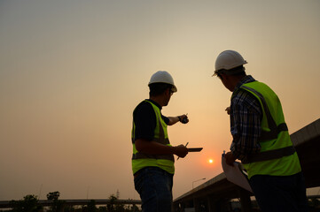 Architect with highway engineering working Discuss and lay out construction project design sheets....