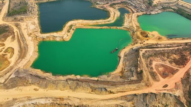 The sand in the quarry may be a range of colors, including beige, brown, gray, or even black depending on the composition of the sand and the surrounding environment. Aerial view from drone. 4K HDR
