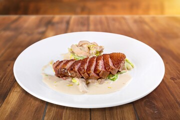 Roasted tasty meat sliced on plate with herbs and spices
