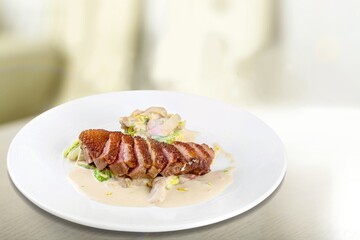 Roasted tasty meat sliced on plate with herbs and spices