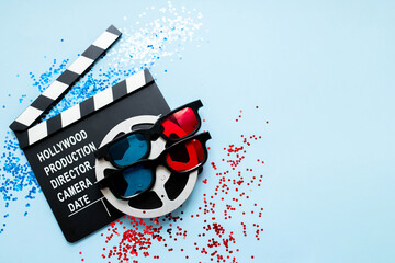 flatlay composition with clapperboard and confetti. movie party concept in red and blue colors ....