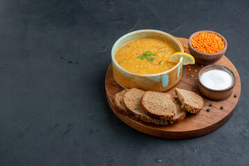 front view lentil soup with salt raw lentils and dark bread loafs on dark surface diner dinner bread horizontal food colourful meal