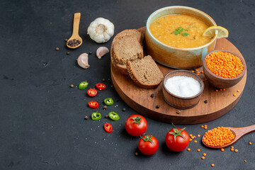 front view lentil soup with salt raw lentils and dark bread loafs on dark surface diner horizontal food colourful dish bread meal