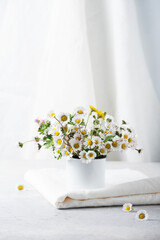 wild daisy flowers and white linen tablecloth