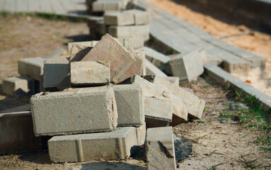 The process of building and repairing a sidewalk paved with brick, a half-built sidewalk road. Sidewalk construction.