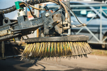 Close-up street sweeper machine cleaning. Concept clean streets from debris. Detail of a road...