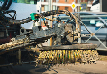 Close-up street sweeper machine cleaning. Concept clean streets from debris. Detail of a road...