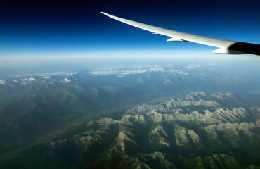 Fototapeta premium Clouds and sky as seen through window of an aircraft