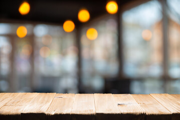 Empty wooden table and blurred cafe background, product display. High quality photo