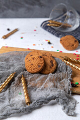 front view chocolate cookies delicious with candles and decors on the white desk biscuit cake sweet tea bake