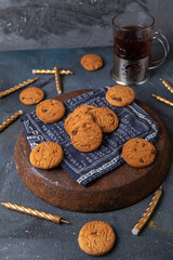 front view delicious chocolate cookies yummy with tea and candles on the dark-grey background cookie biscuit sweet sugar tea