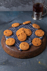 front view delicious chocolate cookies yummy with tea on the dark-grey background cookie biscuit sweet sugar tea