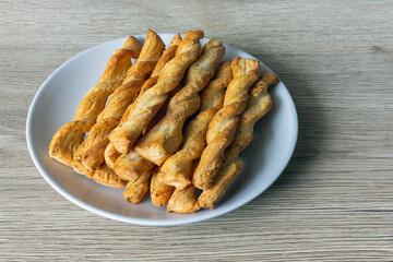 Rolled dough sticks in a plate on the table