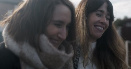 MS TS Female couple embracing and walking outdoors