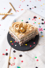 top view delicious cake slice inside plate with candle and little star signs on the light desk cake biscuit sweet sugar