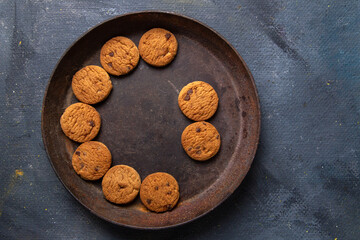 top view delicious chocolate cookies inside brown round plate on the dark-grey background cookie biscuit sweet sugar tea