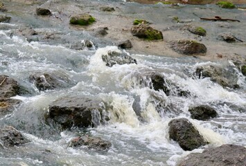 A close view of the flowing water over the rocks. 