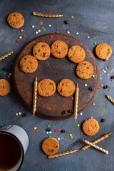 top view delicious chocolate cookies with candles and tea on the dark-grey background cookie biscuit tea sweet