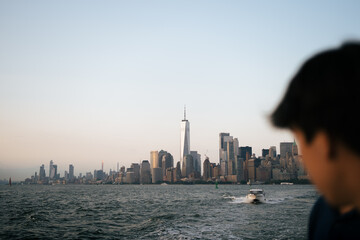 Chico mirando la ciudad de nueva york en un paseo en bote