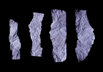 Set of wrinkled purple paper pieces isolated on a black background. Ripped or torn paper.