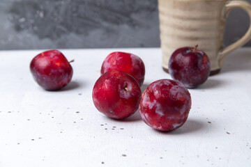 top view red sour plums fresh and ripe all over the white backgorund fruit summer sour