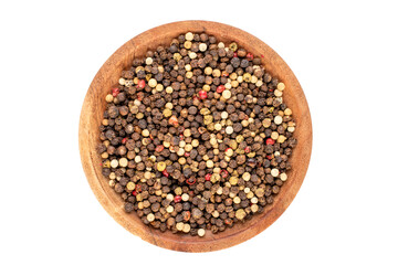 A mixture of four peppercorns on a wooden saucer, macro, isolated on white background, top view.